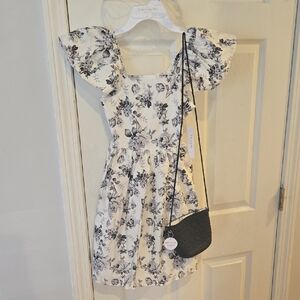 Elegant Floral Dress with Black Bag